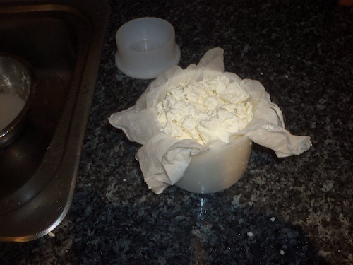 Cheese being put in the mold