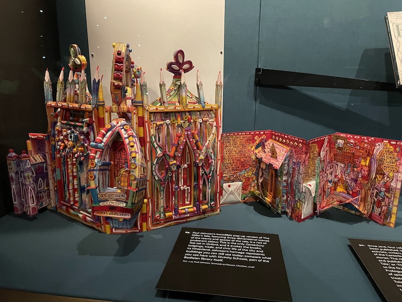 a colourful pop-up book, Serenade to Chaucer, by Paul Johnson. The book features a three-dimensional cover depicting the exterior of Oxford’s Divinity School, and the pages tell the Miller’s Tale alongside envelopes you can unfold and pop-up scenes showing events from the story